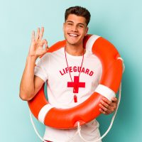 Young caucasian lifeguard isolated on blue background cheerful and confident showing ok gesture.